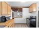 Functional kitchen with wood cabinets, modern appliances, and a view to the living room at 703/709 Patterson St, Clearwater, FL 33756