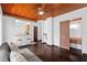 Open living space with hardwood ceiling, wood floors, bar seating and access to the bedroom at 703/709 Patterson St, Clearwater, FL 33756