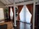 Bright living room with hardwood floors, large windows with curtains, and elegant decor at 703/709 Patterson St, Clearwater, FL 33756