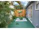 Outdoor patio with table, chairs, and tropical plants with backyard crab art at 703/709 Patterson St, Clearwater, FL 33756