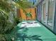 Outdoor patio with table, chairs, and lush tropical plants for relaxation at 703/709 Patterson St, Clearwater, FL 33756