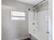 Bright bathroom featuring a shower and window for natural light at 705 3Rd Ne Ave, Largo, FL 33770
