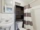 Traditional bathroom with a sink, toilet and shower with curtain at 705 3Rd Ne Ave, Largo, FL 33770