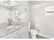 This bathroom features a new vanity with modern fixtures and granite countertop at 705 3Rd Ne Ave, Largo, FL 33770
