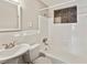Neat bathroom featuring white tile, a sink, and a decorative wall niche at 705 3Rd Ne Ave, Largo, FL 33770