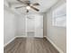 This bedroom features neutral walls, hardwood floors, and a ceiling fan for a comfortable living space at 705 3Rd Ne Ave, Largo, FL 33770
