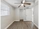 This bedroom features neutral walls, hardwood floors, an overhead ceiling fan and closet for optimal living space at 705 3Rd Ne Ave, Largo, FL 33770