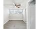 This bedroom features neutral walls, hardwood floors, and a ceiling fan for a comfortable living space at 705 3Rd Ne Ave, Largo, FL 33770