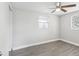 This cozy bedroom features neutral walls, hardwood floors, and a ceiling fan for a comfortable living space at 705 3Rd Ne Ave, Largo, FL 33770