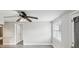 Open concept kitchen with an updated ceiling fan, gray flooring and a window at 705 3Rd Ne Ave, Largo, FL 33770