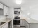 Renovated kitchen featuring granite countertops, stainless steel appliances and gray cabinetry at 705 3Rd Ne Ave, Largo, FL 33770