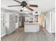Open kitchen featuring granite countertops, modern appliances, gray cabinets, and wood floors at 705 3Rd Ne Ave, Largo, FL 33770