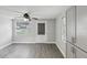 Bright, renovated living room with modern gray flooring, updated windows and a ceiling fan at 705 3Rd Ne Ave, Largo, FL 33770