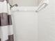 Close up of the shower featuring white tile and a curtain at 705 3Rd Ne Ave, Largo, FL 33770