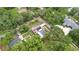 Expansive aerial view of a home with a private pool, mature landscaping, and solar panels at 807 E Chapman Rd, Lutz, FL 33549