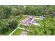Beautiful home with solar panels, a screened pool, and a well-manicured lawn surrounded by mature trees at 807 E Chapman Rd, Lutz, FL 33549