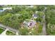 Bird's eye view of a home with a pool, lush greenery, and a tranquil pond nearby at 807 E Chapman Rd, Lutz, FL 33549