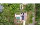 Overhead shot of a house, pool, and adjacent yard in a neighborhood at 807 E Chapman Rd, Lutz, FL 33549