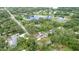 Scenic aerial view of the neighborhood with a home featuring solar panels, a pool, and a large yard at 807 E Chapman Rd, Lutz, FL 33549