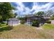 Large backyard featuring a shed and a screened pool area, ideal for outdoor activities and relaxation at 807 E Chapman Rd, Lutz, FL 33549