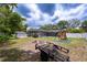 Expansive backyard with a screened pool, playset, and shed, offering ample space for recreation and storage at 807 E Chapman Rd, Lutz, FL 33549