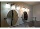 Modern bathroom featuring dual mirrors, contemporary lighting, and tiled accents at 807 E Chapman Rd, Lutz, FL 33549