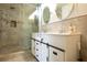 Stylish bathroom boasts a tiled shower, double vanity, and modern fixtures at 807 E Chapman Rd, Lutz, FL 33549