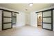 Bright bedroom with frosted sliding barn doors leading to the closet and bathroom at 807 E Chapman Rd, Lutz, FL 33549
