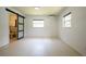 Bright bedroom with dual windows, tile floors, and open bathroom at 807 E Chapman Rd, Lutz, FL 33549
