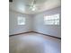 Spacious bedroom with neutral tones, ceiling fan, and two windows for natural light at 807 E Chapman Rd, Lutz, FL 33549
