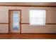 Bright entryway featuring a decorative glass door, natural light, and hardwood flooring at 807 E Chapman Rd, Lutz, FL 33549