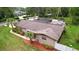 A charming property featuring a well-maintained exterior, solar panels, and lush landscaping at 807 E Chapman Rd, Lutz, FL 33549