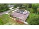 This home features a well-kept lawn, mature trees, solar panels, and a screened pool at 807 E Chapman Rd, Lutz, FL 33549