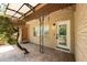 The entryway has a quaint porch, wrought iron features, and unique landscaping enhancing the home's curb appeal at 807 E Chapman Rd, Lutz, FL 33549