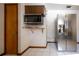 Kitchen area featuring a stainless steel refrigerator, built-in microwave, and white tile flooring at 807 E Chapman Rd, Lutz, FL 33549