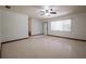 Open living room with ceiling fan and neutral terrazzo flooring at 807 E Chapman Rd, Lutz, FL 33549
