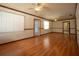Sunlit living room featuring hardwood floors and decorative glass entry door at 807 E Chapman Rd, Lutz, FL 33549