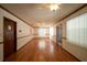 Spacious living room featuring hardwood floors, large windows, and ceiling fans at 807 E Chapman Rd, Lutz, FL 33549