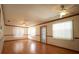 The bright living room showcases hardwood floors, neutral walls, a ceiling fan, and lots of natural light at 807 E Chapman Rd, Lutz, FL 33549