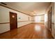Bright living room featuring hardwood floors, large windows, and ceiling fans at 807 E Chapman Rd, Lutz, FL 33549