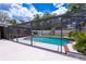 Beautiful screened-in pool and spacious backyard with a playground, designed for Gathering fun and outdoor enjoyment at 807 E Chapman Rd, Lutz, FL 33549