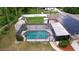 Aerial shot of the screened pool, featuring a brick coping, surrounded by a privacy fence at 807 E Chapman Rd, Lutz, FL 33549