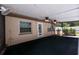 Inviting screened porch featuring ceiling fans, a door to the yard, and neutral siding, ideal for outdoor relaxation at 807 E Chapman Rd, Lutz, FL 33549