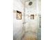 Tiled shower with rain shower head, handheld sprayer, and convenient built-in shower niches at 807 E Chapman Rd, Lutz, FL 33549