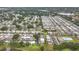 Expansive aerial view of a well-maintained community with serene lakes and mature trees at 8375 Burgundy N Dr, Pinellas Park, FL 33781