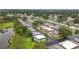Beautiful aerial shot of a tranquil neighborhood with a serene pond and tree lined streets at 8375 Burgundy N Dr, Pinellas Park, FL 33781