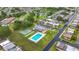Aerial view of community pool and shuffleboard courts near residential area at 8375 Burgundy N Dr, Pinellas Park, FL 33781