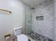 Beautiful bathroom featuring a glass-enclosed shower with grey tile and gold accents at 8375 Burgundy N Dr, Pinellas Park, FL 33781