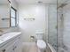 Modern bathroom showcasing a glass-enclosed shower, gold fixtures, and updated vanity at 8375 Burgundy N Dr, Pinellas Park, FL 33781