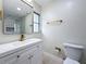 Stylish bathroom with modern vanity, glass-enclosed shower with rainfall showerhead, and gold fixtures at 8375 Burgundy N Dr, Pinellas Park, FL 33781